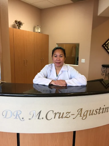 Dr. Maria A. Cruz-Agustin at the front desk of her Ontario dental office
