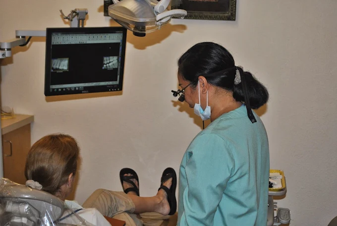 Dr. Cruz-Agustin reviewing digital x-rays with a patient