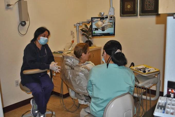 Dr. Cruz-Agustin and an assistant caring for patients